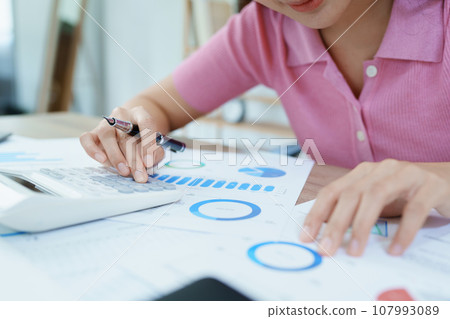 Accountants, Asian auditors are using calculators and computers to review annual tax budgets to submit information to the IRS 107993089