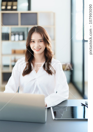 business owner or Asian female marketers are using tablet computer in office work. 107993090