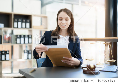 Portrait of a Asian woman lawyer studying a lawsuit for a client before going to court. Portrait of a Asian woman lawyer studying a lawsuit for a client before going to court. 107993154