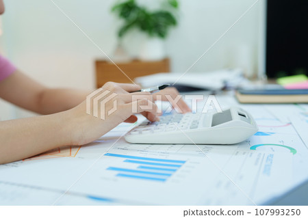Accountants, Asian auditors are using calculators and computers to review annual tax budgets to submit information to the IRS 107993250