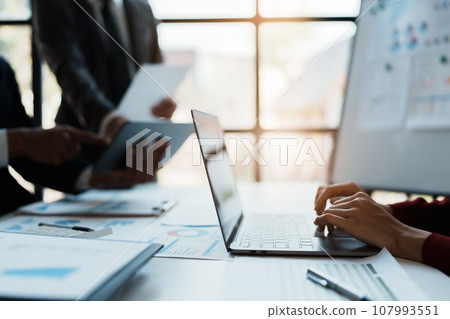 Team business adviser meeting to analyze and discuss the situation on the financial report n the meeting room with using computer laptop, documents, calculator in work 107993551