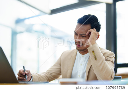 Portrait of sme business owner, man using computer and financial statements Anxious expression on expanding the market to increase the ability to invest in business. 107993789