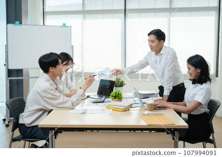 Asian business advisor meeting to analyze and discuss the situation on the financial report in the meeting room.Investment Consultant, Financial , teamwork ,brainstorming ,startup and accounting. 107994091