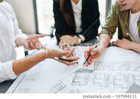 Engineers, designers and interior designers are finalizing the design of interiors by discussing selecting materials and colors to design rooms to present to clients 107994113