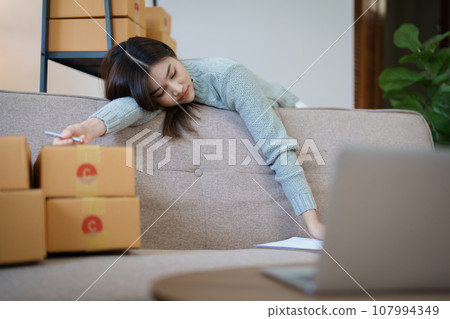 Starting small business entrepreneur of independent Asian woman showing her face worried about the sales of her business not reaching the target set. SME concepts. 107994349