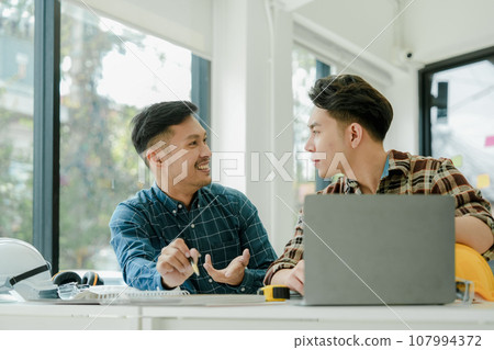 Engineers, designers and interior designers are finalizing the design of interiors by discussing selecting materials and colors to design rooms to present to clients 107994372