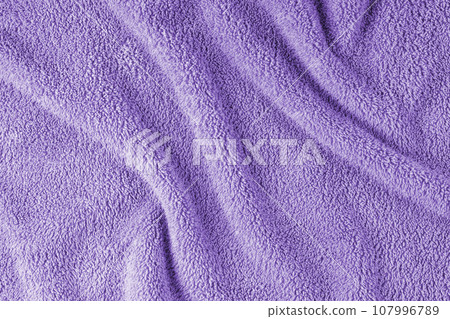 Terry cloth, violet towel texture background. Soft fluffy textile bath or beach towel material 107996789