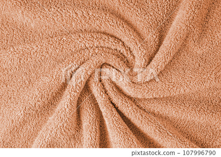 Terry cloth, orange towel texture background. Soft fluffy textile bath or beach towel material 107996790