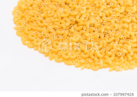 A Heap of Uncooked Chifferi Rigati Pasta on White Background 107997428