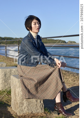 Young woman posing on the beach Young woman posing on the beach 107998025