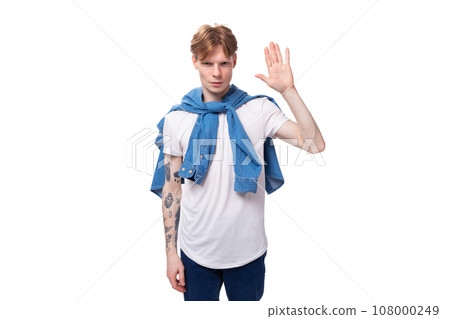 young friendly handsome european man with red hair wears a blue denim shirt over a white t-shirt 108000249