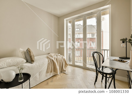 a living room with white walls and hardwood flooring, including a small table that is on the right side 108001330