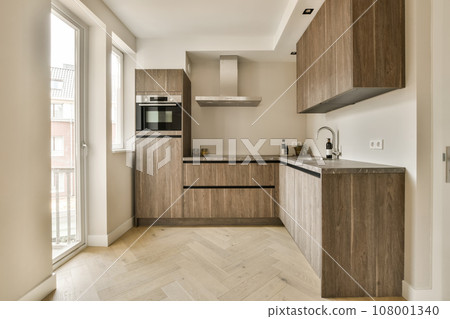 a modern kitchen with wood cabinets and white marble countertops in the room is very clean, but it's not too a modern kitchen with wood cabinets and white marble countertops in the room is very clean, but it's not too 108001340