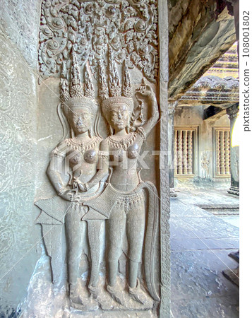 The famous bas-relief of Apsaras, celestial maidens, with intricate hairstyles on the inside wall of the first floor of the Angkor Wat temple in Siem Reap, Cambodia. 108001802