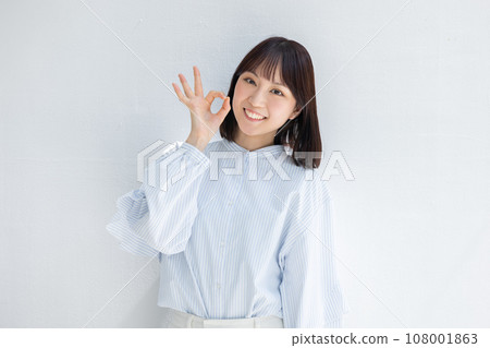 Smiling business woman doing OK pose Smiling business woman doing OK pose 108001863