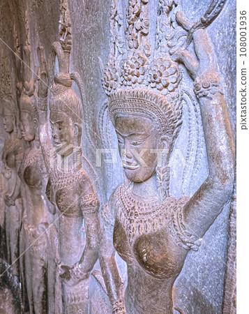 The famous bas-relief of Apsaras, celestial maidens, with intricate hairstyles on the inside wall of the first floor of the Angkor Wat temple in Siem Reap, Cambodia. The famous bas-relief of Apsaras, celestial maidens, with intricate hairstyles on the inside wall of the first floor of the Angkor Wat temple in Siem Reap, Cambodia. 108001936