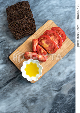 Tomatoes, bread and olive oil. 108002370