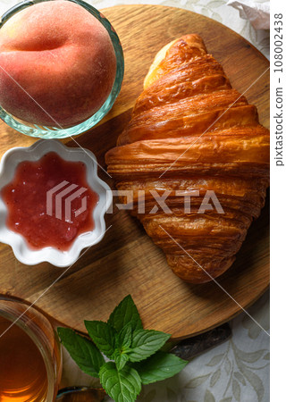 Croissant with tea and jam for breakfast Croissant with tea and jam for breakfast 108002438