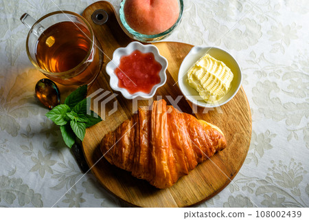 Croissant with tea and jam for breakfast Croissant with tea and jam for breakfast 108002439