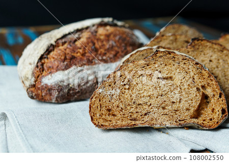 Freshly baked bread with a golden crust close up 108002550