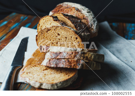 Freshly baked bread with a golden crust close up 108002555