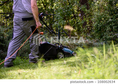 Man Mowing Lawn 108002634