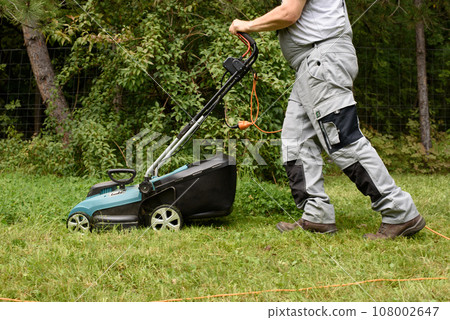 Man Mowing Lawn 108002647