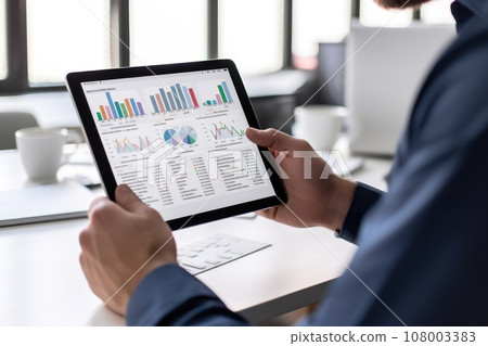 Close-up hand of Businessperson uses a tablet for analysis of business data 108003383