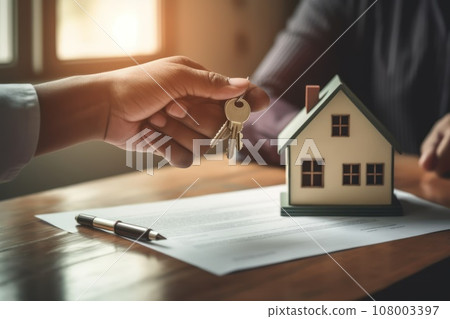 Real Estate Agent Giving Couple Key to a New House 108003397