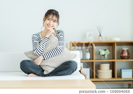 Young woman relaxing on the sofa Woman relaxing at home Woman, smile, girl, casual, college student, new life Young woman relaxing on the sofa Woman relaxing at home Woman, smile, girl, casual, college student, new life 108004088