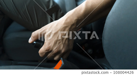 Male hand with handbrake inside the car, closeup view. 108004426