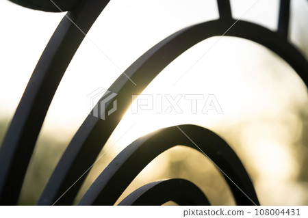 Curved forged modern fence on the balcony closeup. 108004431