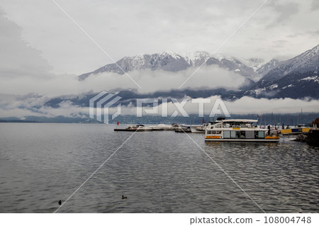 Awe sunny landscape with sheltering sailboat parking lots in water of lake Maggiore in Locarno Awe sunny landscape with sheltering sailboat parking lots in water of lake Maggiore in Locarno 108004748