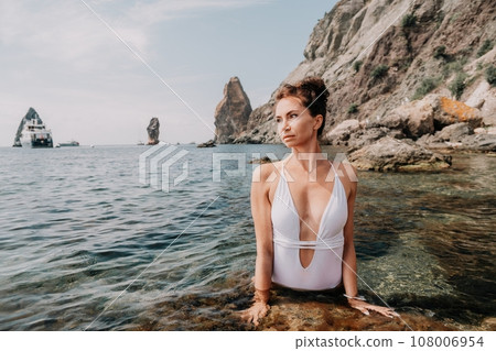 Woman sea fitness. Happy woman in a white bikini performing pilates in the sea on the beach. Female fitness yoga routine concept. Healthy lifestyle. Woman sea fitness. Happy woman in a white bikini performing pilates in the sea on the beach. Female fitness yoga routine concept. Healthy lifestyle. 108006954