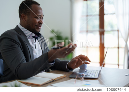 african american man, video call and laptop, wave hello and meeting, consulting or internet planning in startup company. Happy worker greeting for online meeting, computer webinar. african american man, video call and laptop, wave hello and meeting, consulting or internet planning in startup company. Happy worker greeting for online meeting, computer webinar. 108007644