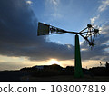 Windmill illuminated by the sunset 108007819