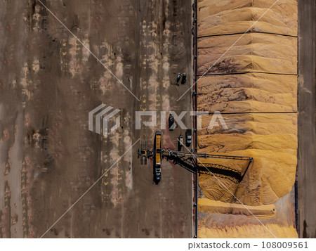 Drone view over grain storage piles being filled and covered Drone view over grain storage piles being filled and covered 108009561