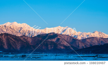 Mt. Jigatake, Mt. Kashimayarigatake, and Mt. Goryu in winter seen from Omachi City (dawn) 108010487