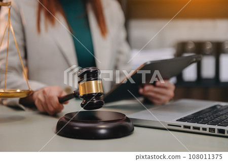 justice and law concept. asian woman lawyer working and judge in a courtroom the gavel, working with tablet and laptop and digital tablet computer justice and law concept. asian woman lawyer working and judge in a courtroom the gavel, working with tablet and laptop and digital tablet computer 108011375