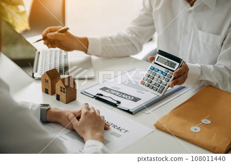 Signing a contract. Client and broker agent, lease agreement, successful deal and Young business sitting at the desk in office Signing a contract. Client and broker agent, lease agreement, successful deal and Young business sitting at the desk in office 108011440