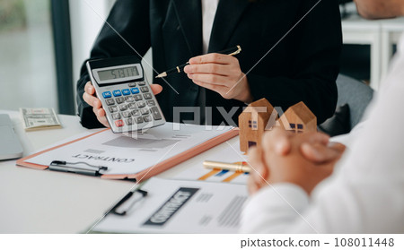 Signing a contract. Client and broker agent, lease agreement, successful deal and Young business sitting at the desk in office Signing a contract. Client and broker agent, lease agreement, successful deal and Young business sitting at the desk in office 108011448