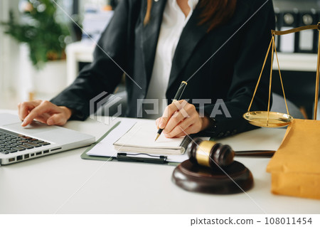 justice and law concept. asian woman lawyer working and judge in a courtroom the gavel, working with tablet and laptop and digital tablet computer 108011454