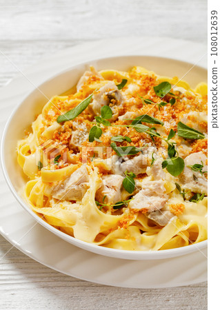 creamy chicken and mushroom tagliatelle in bowl 108012639
