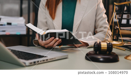 justice and law concept. asian woman lawyer working and judge in a courtroom the gavel, working with tablet and laptop and digital tablet computer justice and law concept. asian woman lawyer working and judge in a courtroom the gavel, working with tablet and laptop and digital tablet computer 108014970