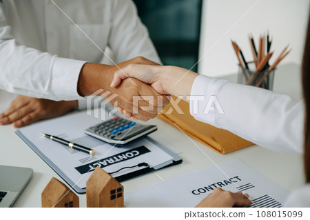 Signing a contract. Client and broker agent, lease agreement, successful deal and Young business sitting at the desk in office Signing a contract. Client and broker agent, lease agreement, successful deal and Young business sitting at the desk in office 108015099