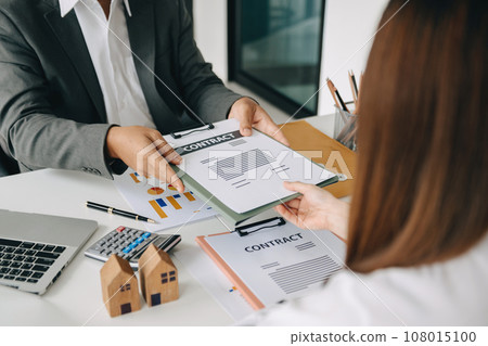 Signing a contract. Client and broker agent, lease agreement, successful deal and Young business sitting at the desk in office Signing a contract. Client and broker agent, lease agreement, successful deal and Young business sitting at the desk in office 108015100