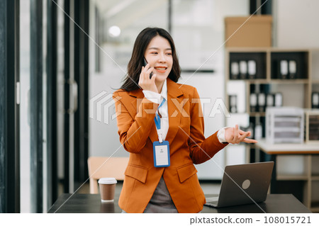 Confident business expert attractive smiling young asian woman holding digital tablet  on desk in creative office. 108015721