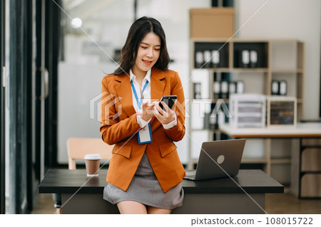 Confident business expert attractive smiling young asian woman holding digital tablet  on desk in creative office. 108015722