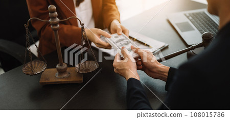 justice and law concept.passing bribe money in the envelop at office. businessman hand taking bribe money from female 108015786