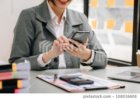 businesswoman working with digital tablet computer and smart phone with financial business strategy layer effect on desk . businesswoman working with digital tablet computer and smart phone with financial business strategy layer effect on desk . 108016608